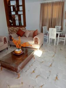 a living room with a couch and a table at Modern and Calm Apartment in Mahdia near Beach in Rejiche