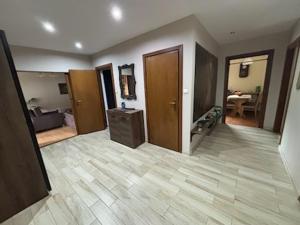 a living room with a large room with a wooden floor at Pod Daglezją in Łagów