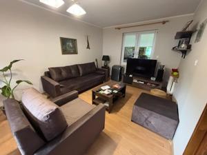 a living room with a couch and a tv at Pod Daglezją in Łagów