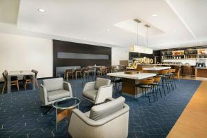 a lobby with chairs and tables and a dining room at Courtyard by Marriott Montvale in Montvale
