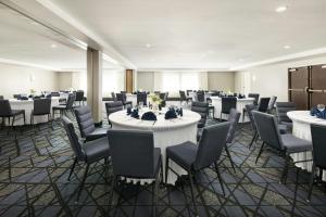 a banquet hall with white tables and chairs at Courtyard by Marriott Montvale in Montvale