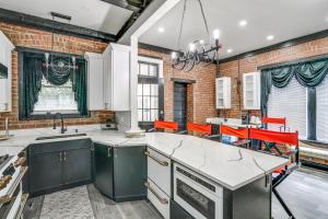 a kitchen with a brick wall at Walkable Schenectady Getaway: 2-Unit Campus Hub in Schenectady