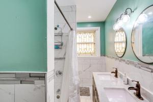 a bathroom with a sink and a shower at Walkable Schenectady Getaway: 2-Unit Campus Hub in Schenectady +37 photos