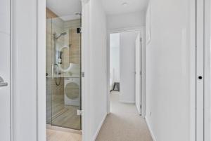 a bathroom with a walk in shower and a glass door at Renovation, location, relaxation in Twizel +8 photos