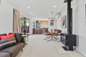 a living room with a couch and a stove at Renovation, location, relaxation in Twizel