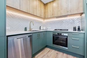 a kitchen with blue cabinets and a sink at Renovation, location, relaxation in Twizel