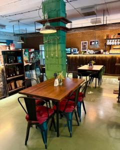a wooden table and chairs in a restaurant at Stara Fabryka Myślniew in Myślniew