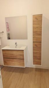 a bathroom with a sink and a mirror at Paradies Caraibes IV in Les Abymes +16 photos