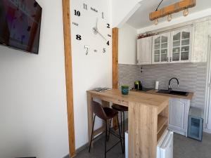 a kitchen with a wooden table in a room at Kutak prirode in Njeguši