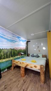 a bedroom with a large bed and a painting on the wall at Kutak prirode in Njeguši