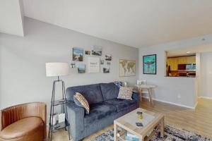 a living room with a blue couch and a table at My Place at Pike Place in Seattle
