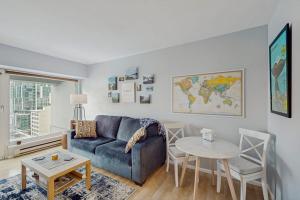 a living room with a blue couch and a table at My Place at Pike Place in Seattle