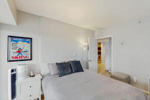 a white bedroom with a bed and a tv at My Place at Pike Place in Seattle +17 photos