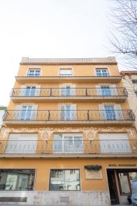 a tall building with balconies on the side of it at Hotel Tall de Conill in Capellades