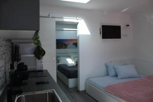 a bathroom with a sink and a bed in a room at Alojamentos Céu Azul in Fernao Ferro +6 photos