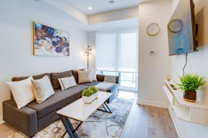 a living room with a couch and a table at Stylish Open Concept Condo with Gym in Kitchener