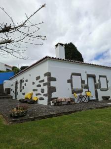 a white building with a mural on the side of it at Home Near the Clouds - Refúgio in Nordeste