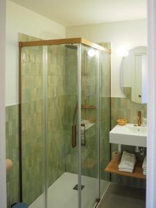 a bathroom with a shower and a sink at Hotel Tall de Conill in Capellades