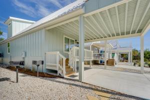 a large white house with a porch and stairs at Brand New Home in Steinhatchee with Rooftop Deck! in Jena