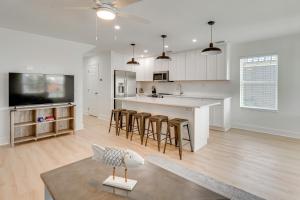 a white kitchen with a bird on a table at Brand New Home in Steinhatchee with Rooftop Deck! in Jena