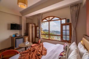 a hotel room with a bed and a window at PACK Shimla in Shimla