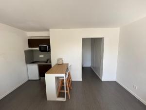 a small kitchen with a table in a room at Appartement Sautron in Sautron