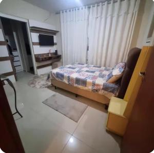a bedroom with a bed and a television in it at Refúgio Aconchego in Sorocaba