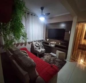 a living room with a couch and a tv at Refúgio Aconchego in Sorocaba