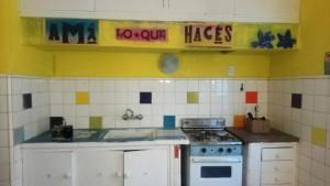 a kitchen with a sink and a stove at Casa JINDRA in Puerto Madryn