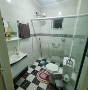 a bathroom with a toilet and a sink at Refúgio Aconchego in Sorocaba +12 photos