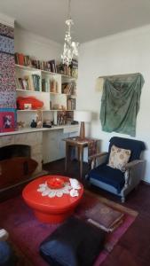 a living room with a red table and a fireplace at Casa JINDRA in Puerto Madryn