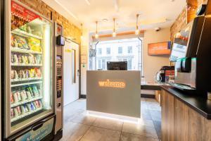 a store with a welcome sign in front of a refrigerator at easyHotel Liverpool in Liverpool