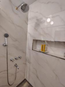 a bathroom with a shower with a shower head at CM Descanso boutique in Colorado River +27 photos