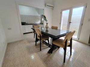 a dining room with a black table and chairs at CM Descanso boutique in Colorado River