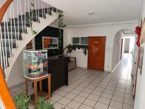 a living room with a staircase and a kitchen at Hostal menavi in León