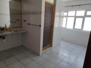 a bathroom with a shower and a sink and a window at Hostal menavi in León