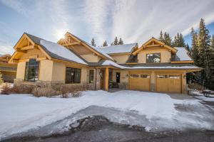 a house with snow on the ground at Creekside Chalet in Big Sky