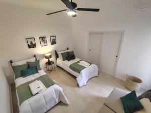 a bedroom with two beds and a ceiling fan at CM Descanso boutique in Colorado River