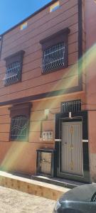 a building with a door on the side of it at Tata hausse in Tatta +3 photos