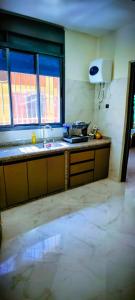a kitchen with a sink and a counter top at Tata hausse in Tatta