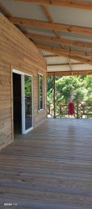 an empty porch of a wooden cabin with a door at Palmeras de Miramar in Miramar