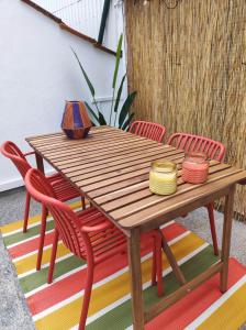 a wooden table with red chairs around it at Vila Real Center Terrace in Vila Real +41 photos