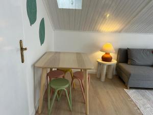 a small room with a table and stools and a couch at Vila Real Center Terrace in Vila Real