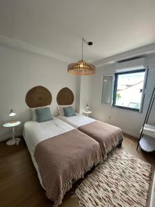 a bedroom with a large bed and a window at Vila Real Center Terrace in Vila Real