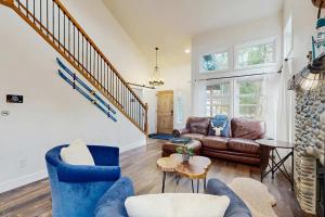 a living room with a couch and a table at Riverfront retreat with panoramic river and forest views in Rhododendron