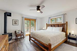 a bedroom with a bed and a ceiling fan at Riverfront retreat with panoramic river and forest views in Rhododendron