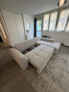 a living room with a couch and a table at Le Contemporain in Troyes