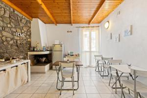 a restaurant with tables and chairs in a room at Bed and Breakfast Cala Luna in Castelsardo