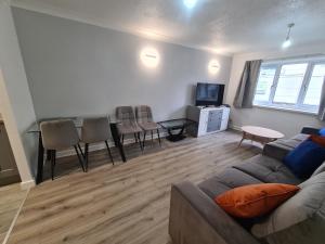 a living room with a couch and a table and chairs at Mailbox and Broad St in Birmingham