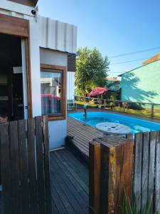 a swimming pool on a deck next to a house at Casas Container Cassino in Rio Grande